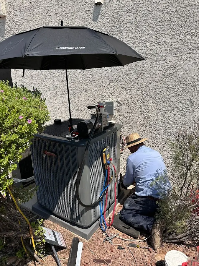 HVAC technician performing outdoor AC maintenance in Campbell